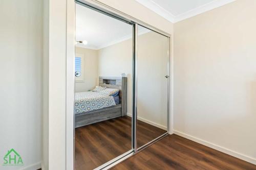 Built-in mirrored wardrobe within a 70m² second storey addition built by Smart Home Additions in Jordan Springs