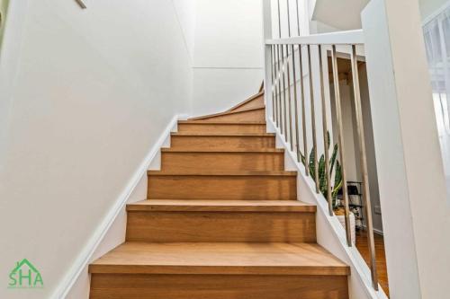 Timber staircase leading to a 70m² second storey addition built by Smart Home Additions in Marayong