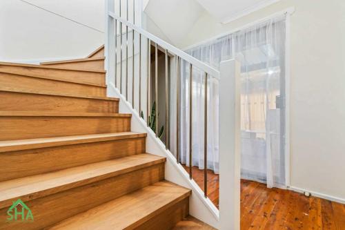 Timber staircase leading to a 70m² second storey addition built by Smart Home Additions in Marayong