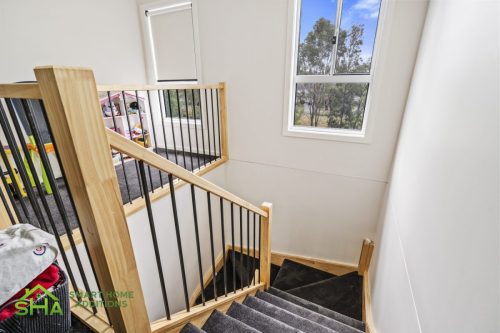 Timber staircase with metal balusters in 60m² second storey addition in Mount Annan