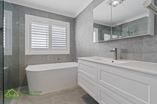 Modern family bathroom in an 80m² second storey addition built by Smart Home Additions in Epping featuring a floating vanity, large mirror and contemporary finishes