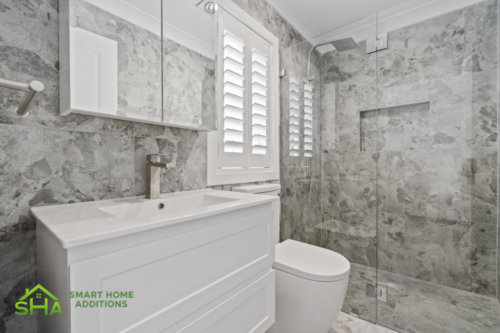 Contemporary bathroom within an 80m² second storey addition built by Smart Home Additions in Epping with floor-to-ceiling tiles and spacious shower