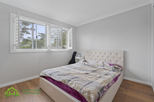 Spacious bedroom in an 80m² second storey addition built by Smart Home Additions in Epping with natural light and modern interior finishes