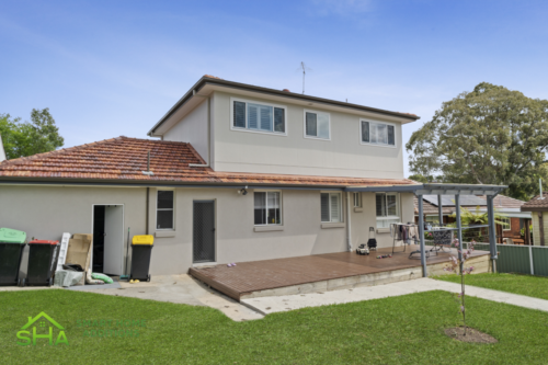 Modern rear exterior of an 80m² rendered second storey addition built by Smart Home Additions in Epping with complementary design features